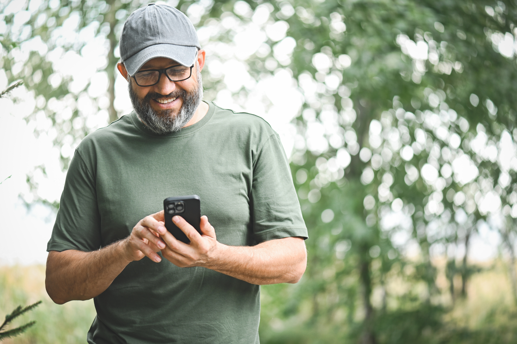 Man using his mobile phone and smiling